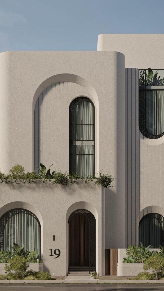 Arched facade detail with planted balconies